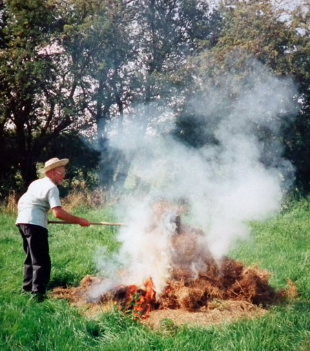 Ken Jackson burning hay; 1997