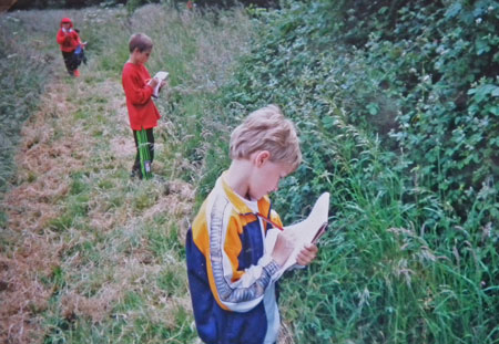 Three children doing nature studies